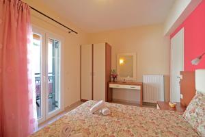 a bedroom with a large bed and a window at Villa Pepy Studio 3 in Mesongi