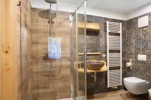 a bathroom with a shower with a sink and a toilet at Agritur Cazzuffi in Peio +76 photos