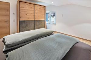 a bedroom with two beds and a closet at Penthouse - Apartment Venosta in Naturno