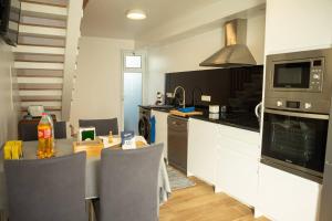a kitchen with a table and a counter top at Casa do Troféu in Relva