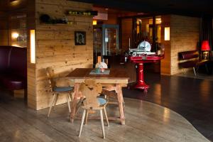 a dining room with a table and two chairs at Komfort Appartements serviced by Auhof in Kaprun