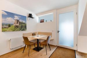 a dining room with a table and chairs and a window at Wolf's Apartment Rheintal in Renchen