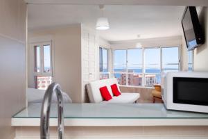 a kitchen with a bed and a microwave in a room at Seaviews A61 in Torrox Costa