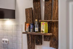 a shelf on a wall with bottles on it at Kolbatzer Mühle in Lychen +110 photos