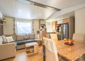 a living room with a couch and a table at Mh324 La Tremblade in La Tremblade