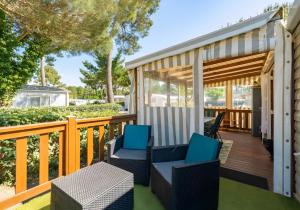 a deck with two chairs and a table at Mh324 La Tremblade in La Tremblade