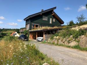 a green house on the side of a road at Haus Leenja in Beverungen