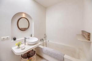 a white bathroom with a sink and a mirror at Casa De La Mar 19 in Colonia de Sant Pere +18 photos