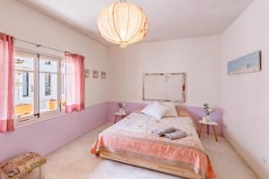 a bedroom with a bed and a chandelier at Casa De La Mar 19 in Colonia de Sant Pere