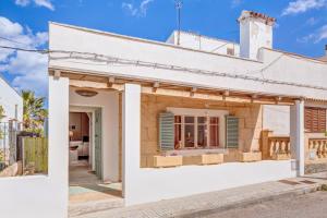 a white house with a white facade at Casa De La Mar 19 in Colonia de Sant Pere