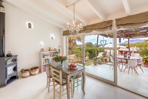 a dining room with a table and a large window at Casa De La Mar 19 in Colonia de Sant Pere