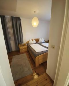 a small bedroom with a bed and a light at Fewo Forchheim in Forchheim