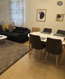 a living room with a table with two laptops on it at Fewo Forchheim in Forchheim +4 photos