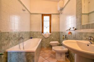 a bathroom with a tub and a toilet and a sink at Casa Valeria Costa Paradiso in Trinità d'Agultu e Vignola +22 photos