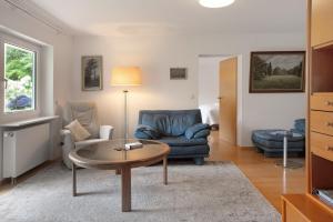 a living room with a couch and a coffee table at Secret Garden in Müllheim