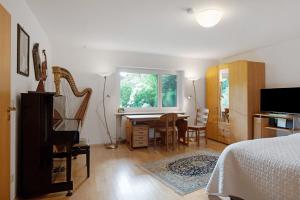 a bedroom with a bed and a desk and a table at Secret Garden in Müllheim