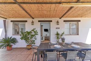 a patio with a blue table and chairs at Villa Torrox Costa con Piscina in Torrox