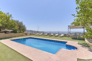 a swimming pool in the yard of a house at Villa Torrox Costa con Piscina in Torrox