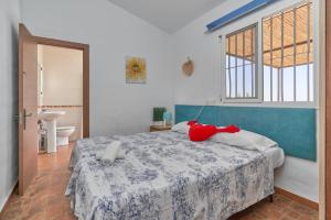 a bedroom with a bed and a window and a bathroom at Villa Torrox Costa con Piscina in Torrox +23 photos