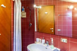 a bathroom with a sink and a mirror at Loft parallela lungomare posto auto in Viareggio +12 photos