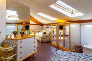 a bedroom with skylights and a room with a bed at Loft parallela lungomare posto auto in Viareggio
