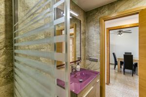 a bathroom with a purple sink and a table at Riells Platja in L'Escala +12 photos
