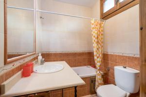 a bathroom with a sink and a toilet at Casa Rocío Castril in Castril +29 photos