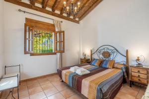 a bedroom with a bed and a window at Casa Rocío Castril in Castril