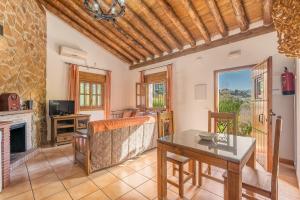 a living room with a table and a fireplace at Casa Rocío Castril in Castril