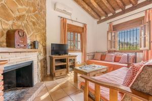 a living room with a fireplace and a couch at Casa Rocío Castril in Castril