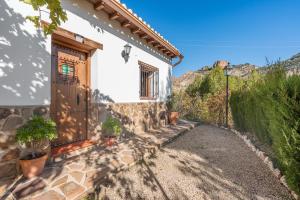 a house with a door and some plants on the side at Casa Rocío Castril in Castril
