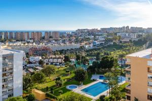 an aerial view of a city with a pool and buildings at Sky Costa Del Sol in Torremolinos