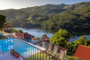 a swimming pool with a view of a river at Casa Pinhão De Sousa in Vieira do Minho
