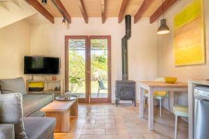 a living room with a couch and a table and a stove at Redonda 2 in Costitx