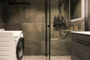 a bathroom with a washing machine and a shower at Beitostølens smørblomst in Beitostøl +23 photos