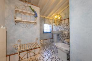 a bathroom with a toilet and a sink and a window at San Giovanni Residence in Peccioli +72 photos