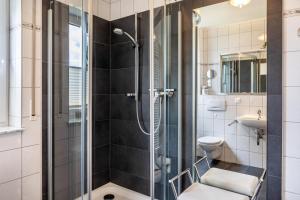 a bathroom with a shower and a toilet and a sink at Ferienwohnung Tannenblick 6-1 in Oberhof +19 photos