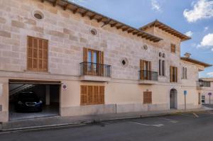 a building with a car parked in a garage at Can Maro in Santa Margalida