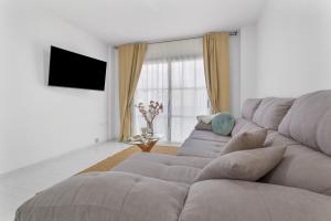 a living room with a couch and a television at Retama in Adeje