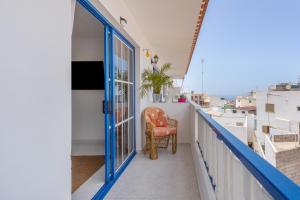 a balcony with a chair and a window at Retama in Adeje
