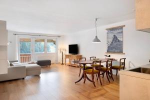 a kitchen and living room with a table and chairs at Panorama Apartment Todtmoos in Todtmoos