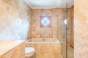 a bathroom with a tub and a toilet and a shower at Can Maro in Santa Margalida +22 photos