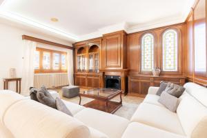 a living room with a white couch and a fireplace at Can Maro in Santa Margalida