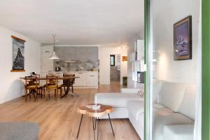 a living room and kitchen with a couch and a table at Panorama Apartment Todtmoos in Todtmoos