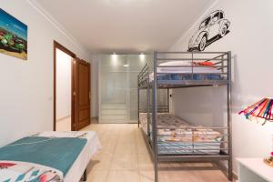 a bedroom with two bunk beds with a car on the wall at Casa Angel A 3 in Corralejo +35 photos
