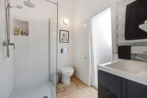 a bathroom with a shower and a toilet and a sink at Casa Doce in Silves +30 photos