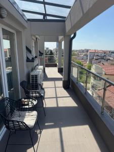 a balcony with chairs and a view of a city at River View Ruse, Free,underground Parking in Ruse