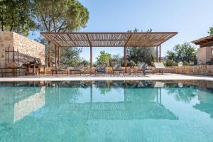 a swimming pool with a gazebo and some chairs at Es Lledoner 2 in Islas Baleares