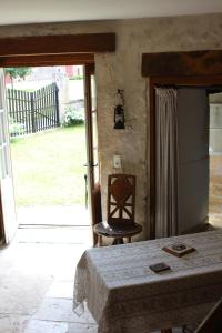 a bedroom with a bed and a door to a yard at Gites Du Château De Saveilles in Paizay-Naudouin
