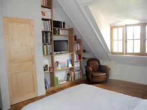 a bedroom with a bed and a book shelf at Moulin du Tourous - Chambre 1 in Plouédern
